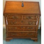 A good quality 20thC oak fall front bureau. Cross banding to fall front and drawers with brass
