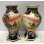 A pair of Japanese Noritake decorative vases 25cm h with blue ground gilded with scenes of Arabian