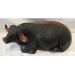 A large carved solid wood figure of a bull. 16cms h x 38cms l.Condition ReportSome shrinkage