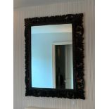 A carved dark oak mirror. 110 h x 85 wCondition ReportSlight cracks to frame in places.