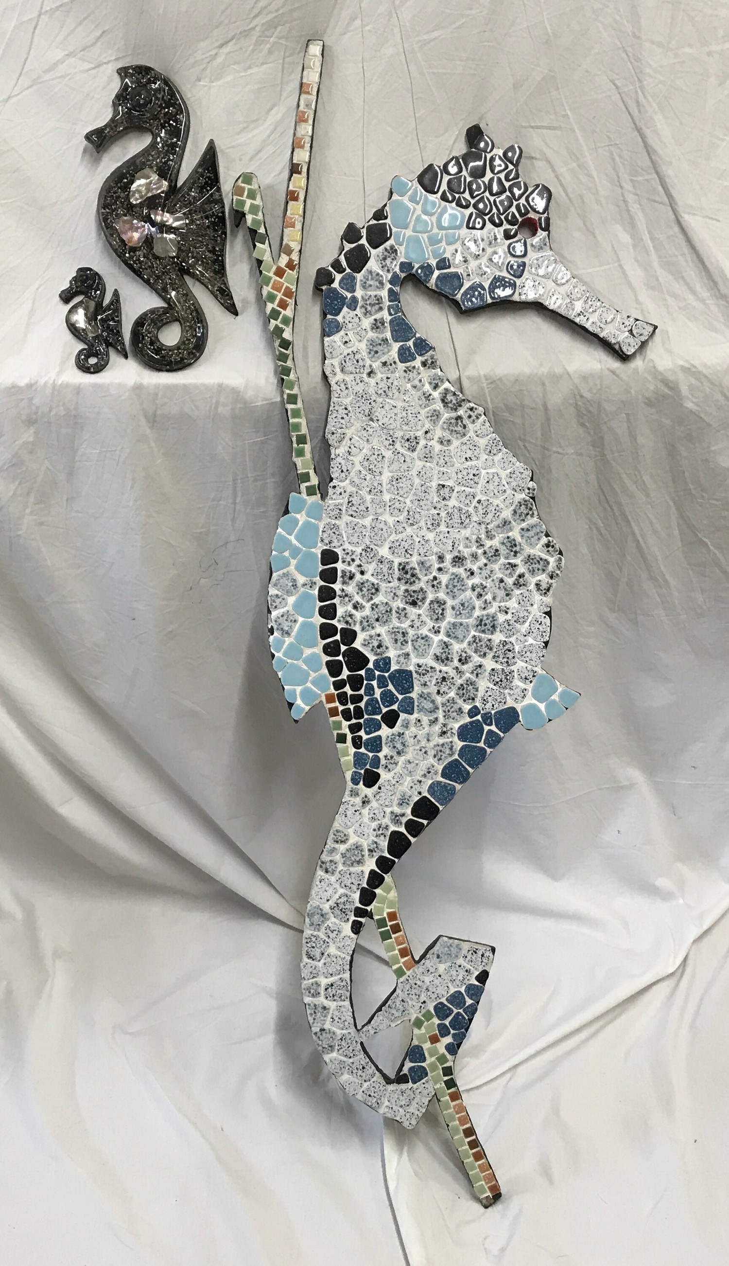 A large wall mounted mosaic seahorse 117cms h together with two small Shellart seahorse figures