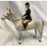 A Beswick Huntswoman on white/grey dappled horse. Approx. 21.5cms h x 21cms l.Condition ReportVery