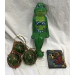 Three green glass fishing floats 14cms w, a large papier maché female frog 52cms h and a studio