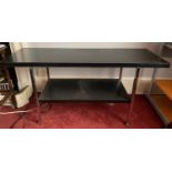 A two tier black Formica and chrome coffee table on castors. 120 w x 41 d x 58cms h.Condition