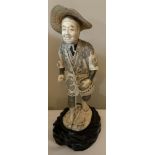 A good quality Meiji period carved ivory figure of a male with a basket. 30cms h.Condition