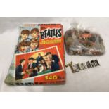 The Beatles, 340 piece jigsaw puzzle and a novelty brooch of book form with pull out portfolio