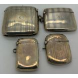 Four hallmarked silver vesta cases, three with engine turned decoration and one plain. Total