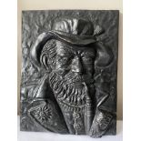 A black cast iron plaque of the Old Man smoking a pipe.