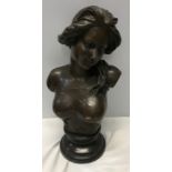 A reproduction bronze bust of a semi nude female on a slate base stand signed to the back J. Gerome.