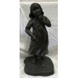 A large resin bronze effect figure of a young girl in a thoughtful pose with bare feet made by