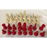 A carved bone red and white chess set. Complete.Condition ReportOne red pawn with glued tip. Overall