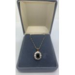 A 9ct gold drop pendant set with central sapphire and diamond chips. 51cms l chain. 2.5gms total.