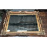 A gilt framed bevel edged wall mirror. Frame 65cms h x 85cms w.Condition ReportChips to gesso