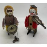 Two Schuco tin plate clockwork musicians, a drummer and a violinist. 11cms h. Working order.