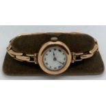 A lady's 9 ct gold wristwatch and expanding strap. 24gms total weight.