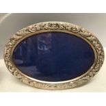 Two hallmarked silver oval photo frames by B & Co Birmingham 1987. 17cms w x 11.5cms h and 8cms w