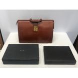 A collection of 3 leather brief cases to include a tan leather Doctors bag opening brief case