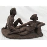 A bronze effect resin figurine of a nude study of young couple. Initialled signed indistinctly No.