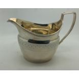 Silver creamer with bright cut engraving, 1804, makers mark indistinct. 104gms.Condition
