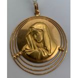 An 18ct gold circular pendant depicting The Virgin Mary, 14.3gms. 4.5cms d.Condition ReportGood