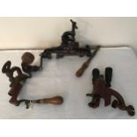 Three cast iron and brass shotgun cartridge vice re loaders, one James Dixon and Sons, lever