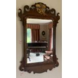 A mahogany fretted wall mirror with gilt bird. 78cms x 46cms.Condition ReportGood condition.