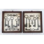 Two wall mounted display cabinets of Georgian keys, Largest key 17cms l. Cabinet size 28.5cms x