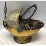 A large brass coal helmet with shovel. Hammered finish with wrought iron handles. Approx. 42cms h