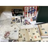 A box of miscellaneous stamp albums and coins.