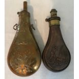 Two copper and brass gunpowder flasks. U.S reproduction flask 23cms and a copper flask embossed