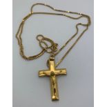 An 18ct gold crucifix and 18ct 70cms l chain. 19.6gms total weight.