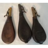 Three leather gunpowder flasks, one with embossed hunting dog design, largest 23cms l.Condition