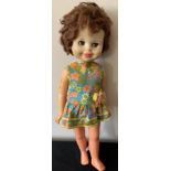 A 1960's doll in original dress. 54cms h.Condition ReportPlay worn, overall good condition.