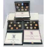 Royal Mint UK proof coin collection in blue cases 1983. 1984 and 1985 with a Welsh £1 coin.Condition