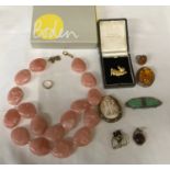 A small selection of costume jewellery including a yellow metal ring, a Caroline Charles rabbit