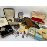 A miscellany to include glass key hole cover, Timex watch, miniature lighter, charms, costume