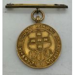 A 9ct gold Yorkshire County Bowling Association medal suspended on a gilt metal pin. Inscribed to