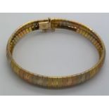 A tri colour 18ct gold bracelet. 18.5 l, 25gms weight.Condition ReportGood condition.