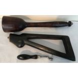 Wooden gun barrel tamper, 36cms l, 8cms w, a rifle butt with brass mounts, metal butt end and a