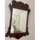 A small mahogany fretted wall mirror.Condition ReportMarks to mirror. 65 h x 38cms w.