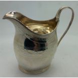 Silver creamer with bright cut engraving, London 1796, makers mark indistinct. 101gms.Condition