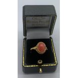 A 9ct gold lady's dress ring set with single coral stone. Size N/O.Condition ReportGood condition.