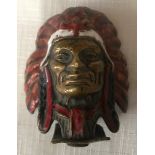 An Indian chief commercial vehicle mascot in enamel painted brass. Approx 6cms h x 5.5cms w.