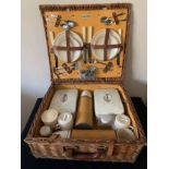 A vintage wicker Sirram picnic basket complete with contents. 46 x 42 x 18cms.Condition ReportOne