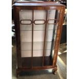 A walnut veneered single door china cabinet with cabriole legs. 71cms w x 35cms d x 121cms h.