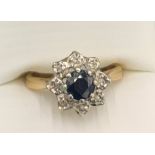 A 9ct gold cluster ring set with sapphire surrounded by diamonds. Size P. 3.1gms.Condition