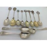 Ten various hallmarked silver souvenir spoons and one white metal spoon. 141gms total weight.