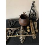 A selection of metal ware to include a decorative brass towel rail, cast iron brackets, brass door