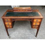 An Edwardian rose wood inlaid desk with green leather top , 6 drawers and square legs. 92cms w x