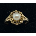 A 9ct gold and pearl dress ring, size "0", 3gms.